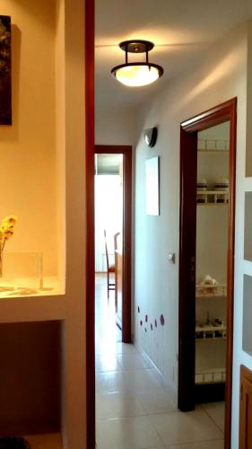 a hallway with a door leading to a dining room at Apartamento turístico en Porto do Son in Porto do Son
