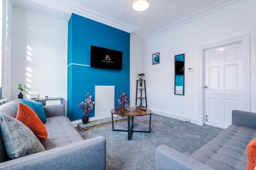 a living room with a couch and a table at Entire house in Dukinfield in Dukinfield