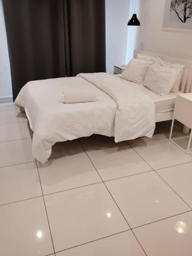 a white bed sitting on top of a white tiled floor at Morgan’s Garden in Accra