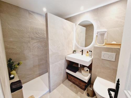 a bathroom with a sink and a mirror at Le Mas de Mougins in Mougins