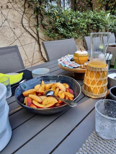 a table with a pan of fruit on it at Le Mas de Mougins in Mougins