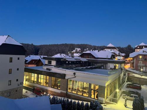 a building with lights on in a city at night at Apartman Stefan Zlatibor in Zlatibor