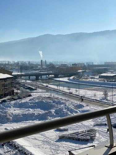 a view of a river with snow on the ground at Waves 605 River View in Sarajevo