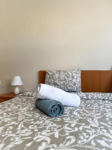 a pair of towels sitting on top of a bed at Ground Apartment AXD in Alexandroupoli
