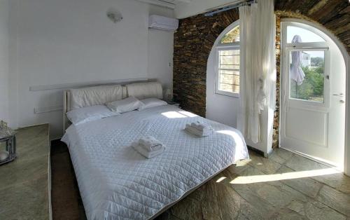 a bedroom with a bed with towels on it at Apollon-Artemis Apartments in Apollonia