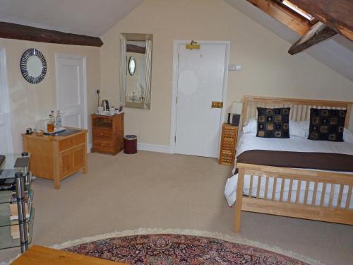 a bedroom with a bed and a dresser in it at Town Mills in Dulverton