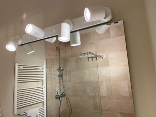 a bathroom with a shower with a glass shower at Kristof701 in De Panne