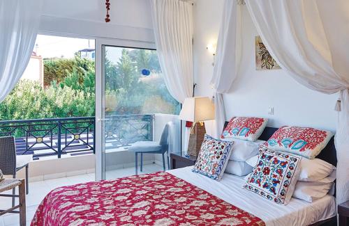 a bedroom with a bed and a balcony at Villa Francesca in Kalathos