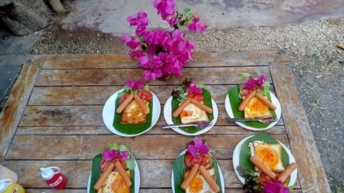eine Gruppe von Lebensmittelplatten auf einem Tisch in der Unterkunft navaa Bungalow in Phra Ae beach