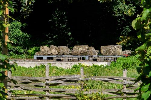 a group of rocks sitting on top of a fence at La Domus Lemaitre 1, plain-pied, Wifi , TV, parking, jardin in Bavay