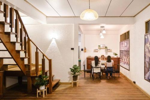 two women sitting at a table in a room at Just renovated in walking street in Chiang Khan