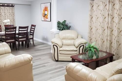 a living room with a couch and chairs and a table at Cozy Luxurious Detached 4 Bedroom House in Guelph