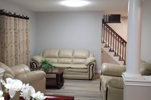 a living room with a couch and a table at Cozy Luxurious Detached 4 Bedroom House in Guelph