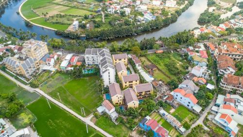 an aerial view of a city next to a river at Palm Boutique Village - STAY 24H in Hoi An