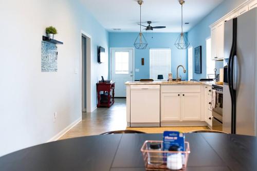 a kitchen with blue walls and a table in the foreground at Clean & Serene House Studio - Easy Onoff I-40 in Memphis