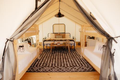 a room with two beds in a tent at XLg Porch Deluxe glamping tents @ Lake Guntersville State Park in Guntersville