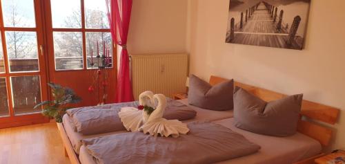 two beds with swans on them in a room at Schöne Ferienwohnung im Luftkurort Hauzenberg in Hauzenberg