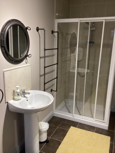 a bathroom with a shower and a sink and a mirror at Room to rent in Mullingar