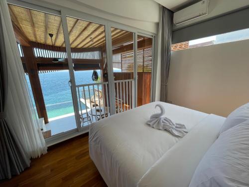 a bedroom with a bed with a view of the ocean at The Angsa villas in Amed