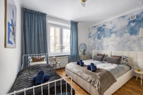 a bedroom with two beds and a large window at 7Heaven Dream - City Center in Warsaw