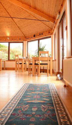 a dining room with a table and a rug at Lochview House in Fort William