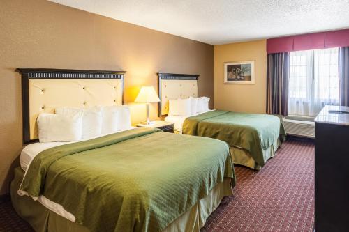a hotel room with two beds and a window at Quality Inn & Suites in Lincoln