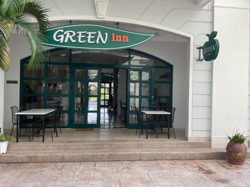 a green inn restaurant with tables and chairs outside at Green Inn Phu Quoc Hotel in Phu Quoc
