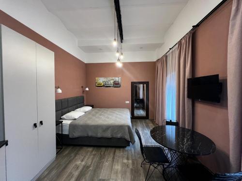 a hotel room with a bed and a table at Chikhi in Tbilisi City
