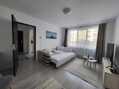 a bedroom with a bed and a large window at Cosy Elegant Apartment in Cehu Silvaniei