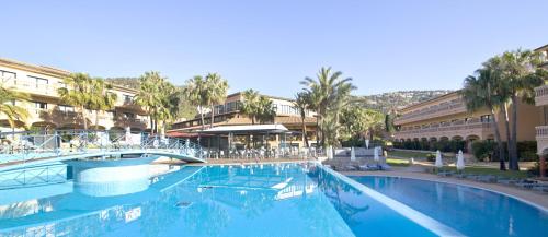 a large swimming pool with a bridge in a resort at Mon Port Hotel & Spa in Port d’Andratx