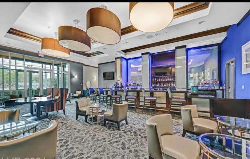 a restaurant with tables and chairs and a bar at Princess Suite Platinum Hotel in Las Vegas