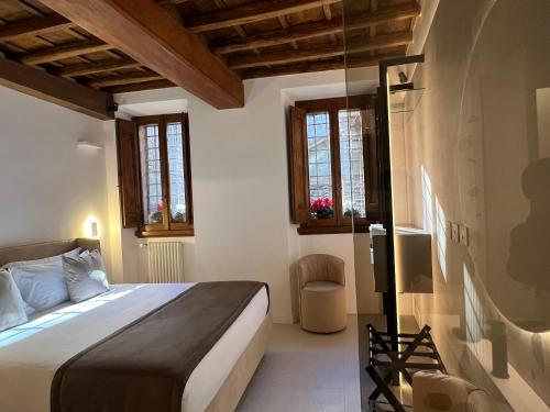 a bedroom with a bed and some windows at Affreschi al Pantheon in Rome