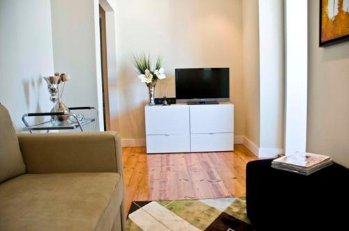 a living room with a couch and a flat screen tv at Cosy and Renewed T2 Apartament in Campolide - 67 1D in Lisbon