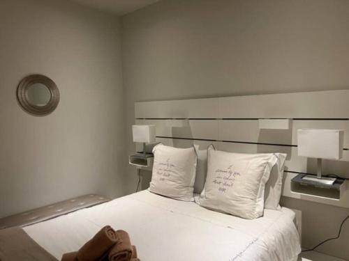 a bedroom with a bed with white sheets and two pillows at Cosy and Renewed T2 Apartament in Campolide - 67 1D in Lisbon