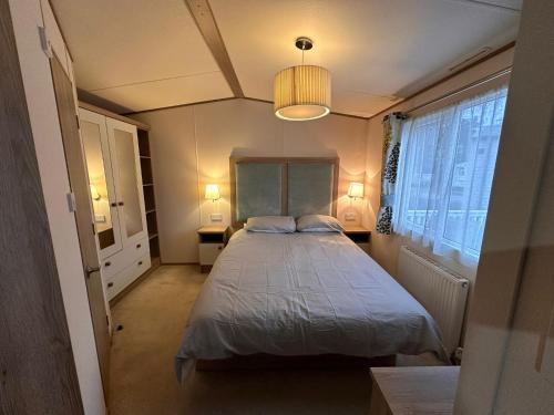 1 dormitorio con 1 cama y 2 luces encendidas en Tattershall Lakes 6 berth with bath, en Tattershall