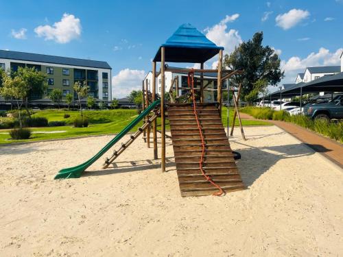 a playground with a slide in the sand at Lethabo Eco_Estate in Boksburg