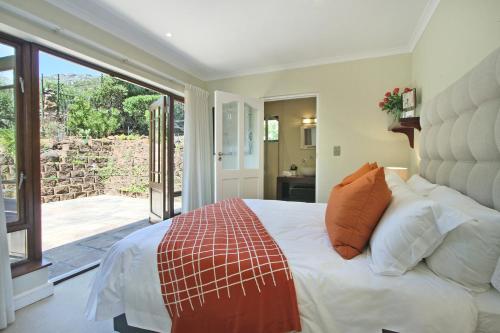 a bedroom with a large bed and a sliding glass door at Villa Arena in Cape Town