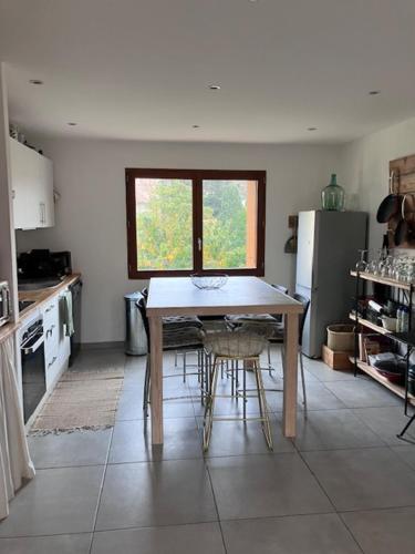 a kitchen with a table and chairs in a room at T3 - coeur de Port-Vendres RDC Cour in Port-Vendres