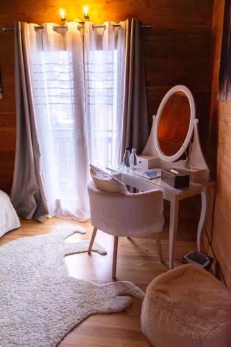 a bathroom with a vanity with a mirror and a sink at Chambres et table d'hôtes au chalet Datcha in Briançon