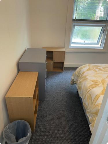 a bedroom with a desk and a bed and a drawer at Lovely room in Tottenham in London