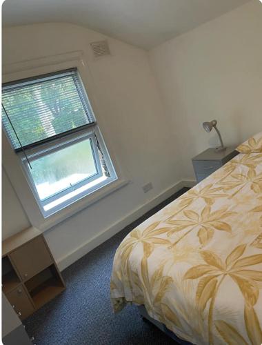 a bedroom with a bed and a window at Lovely room in Tottenham in London