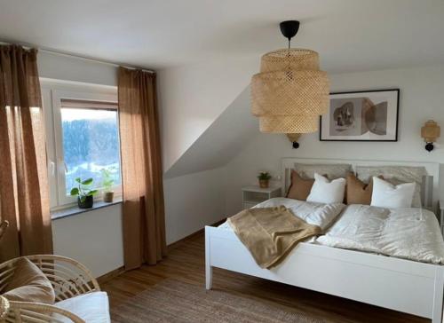 a bedroom with a white bed and a window at Morgensonne in Arnoldshammer