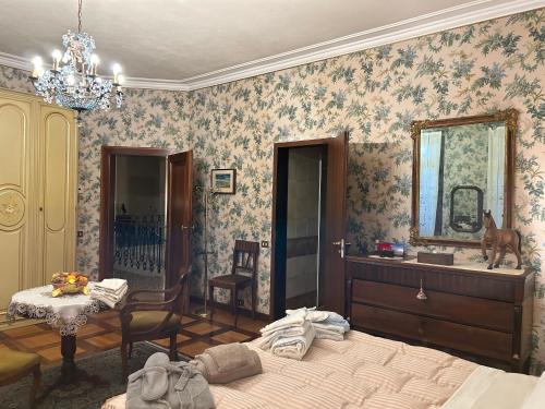 a bedroom with a bed and a table and a mirror at Villa Carla - Camera King Superior in Padova