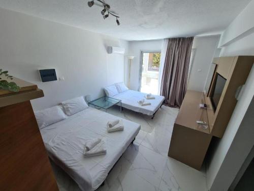 a small room with a bed and a couch at Fotoxenia Luxury Apts in Paralimni