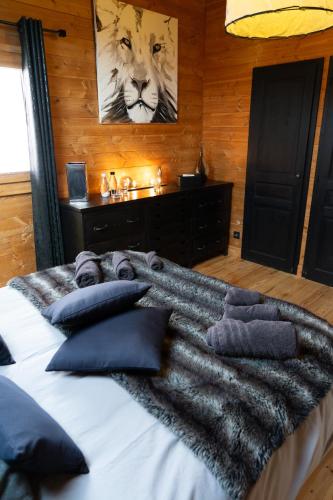 a bed with a blanket and pillows on it at Chambres et table d'hôtes au chalet Datcha in Briançon