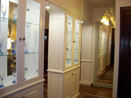 a room with white cabinets with glasses in it at Villa Graziella Perugia in Perugia