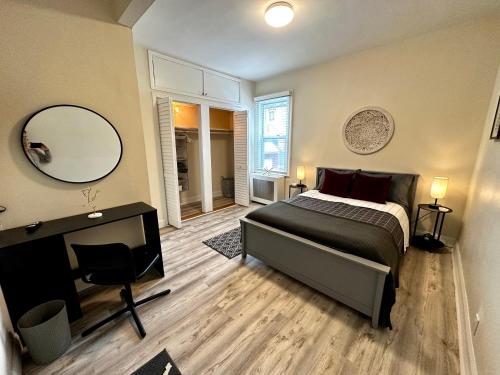 a bedroom with a bed and a desk and a mirror at 2-A Diamond in Yonkers in Yonkers