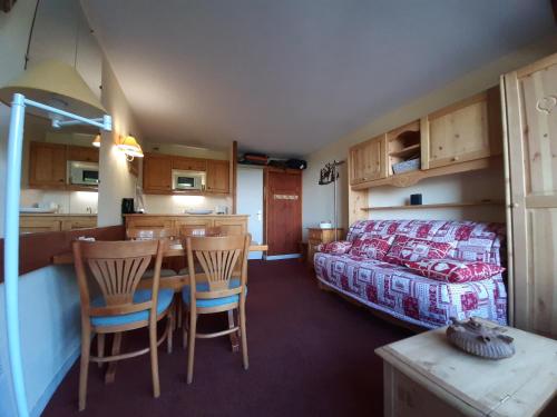 une chambre avec un lit, une table et des chaises dans l'établissement Le RUITOR, à Bourg-Saint-Maurice