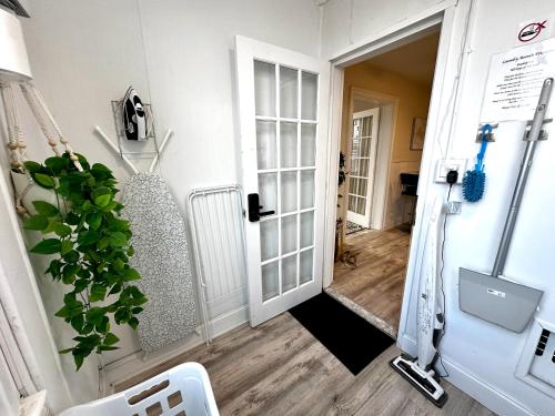 a hallway with an open door with a plant at 2-A Diamond in Yonkers in Yonkers
