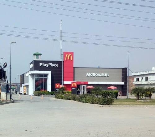 a mcdonalds store with a sign on the front of it at Executive Apartments in Gujrānwāla